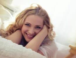 Donna sorridente sdraiata sul divano